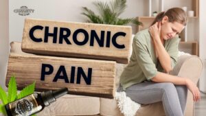 A bottle of CBD oil standing next to a person experiencing back pain, symbolizing natural support in chronic pain management.