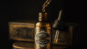 Macro of a glass pipette above a Canasity CBD oil bottle with a single golden drop suspended mid-air